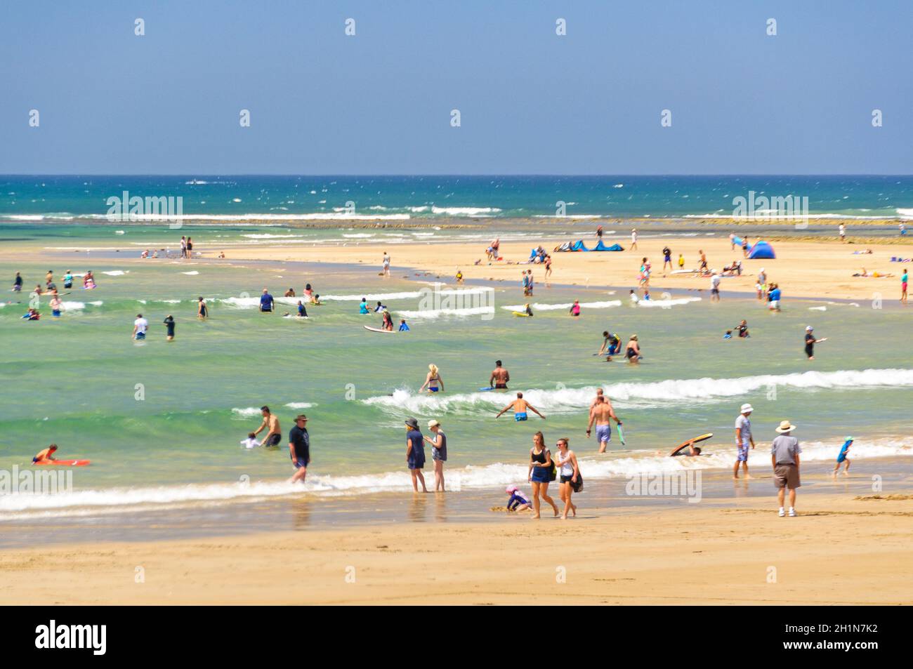 Vacationers and locals alike have a great time on the sandy Front Beach at Point Danger - Torquay, Victoria, Australia Stock Photo