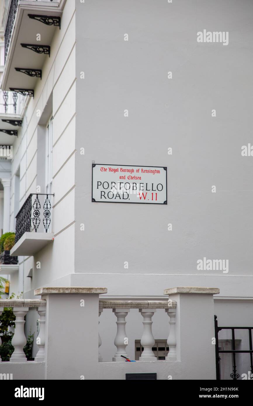 Address sign for Portobello Road on white building with balconies. Address sign on bright British house from Chelsea, London. Peaceful London neighbor Stock Photo