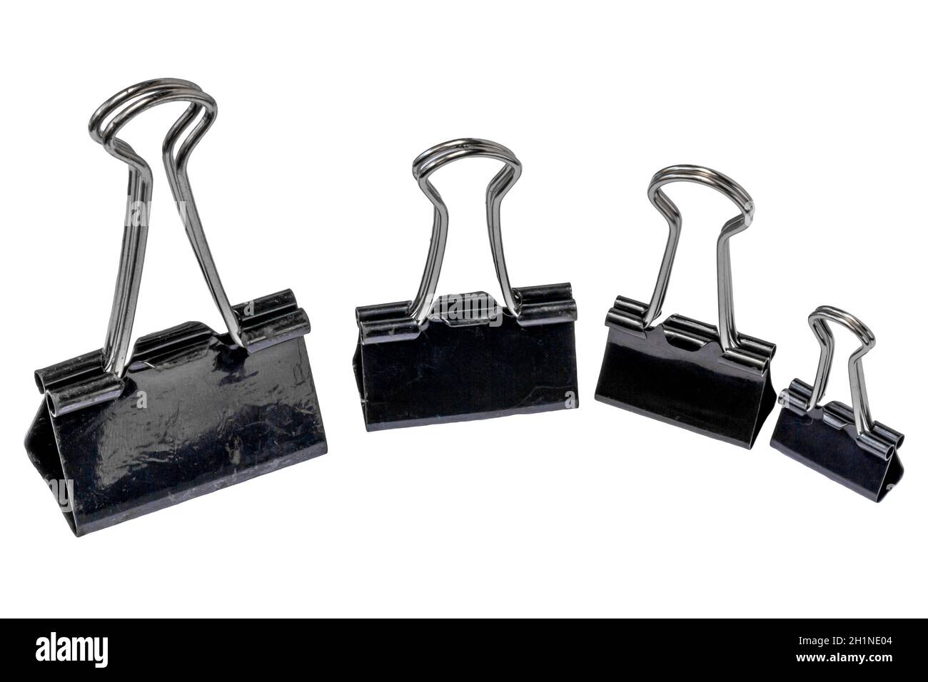 Four black metal paper clips, isolated with a white background, for