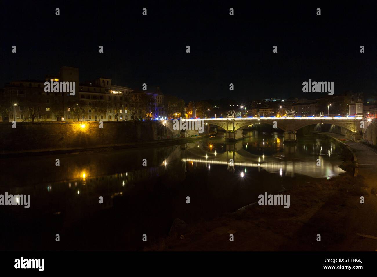 Night scene of Rome, Tevere river with city in background. Italian landmark Stock Photo