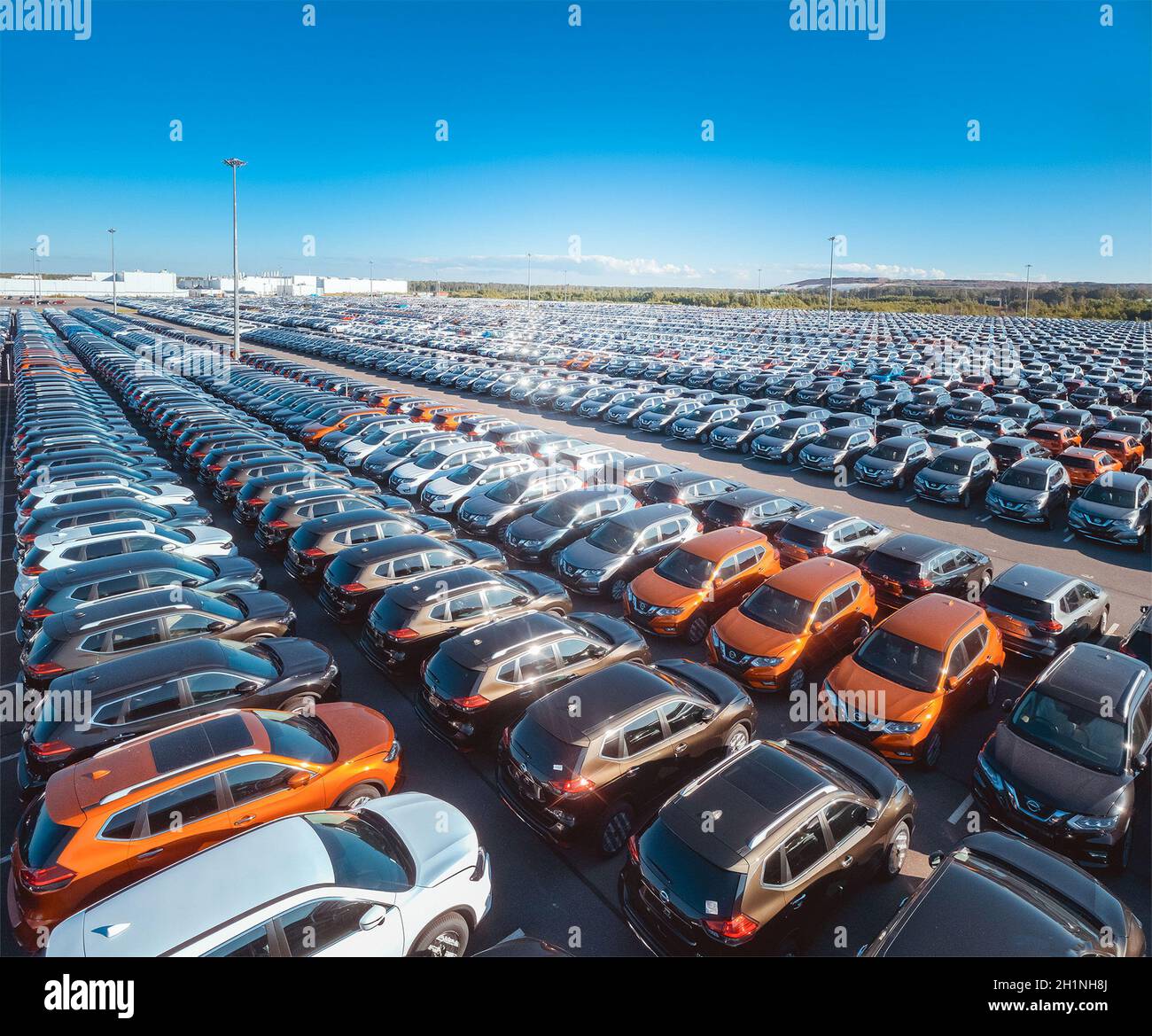 Large parking lot of new cars waiting for delivery and export, at