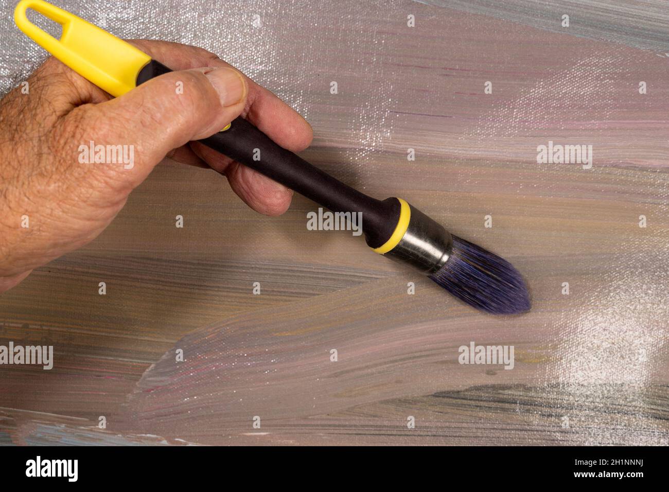 Brushes for painting  lying on an old canvas painted with oil paints Stock Photo