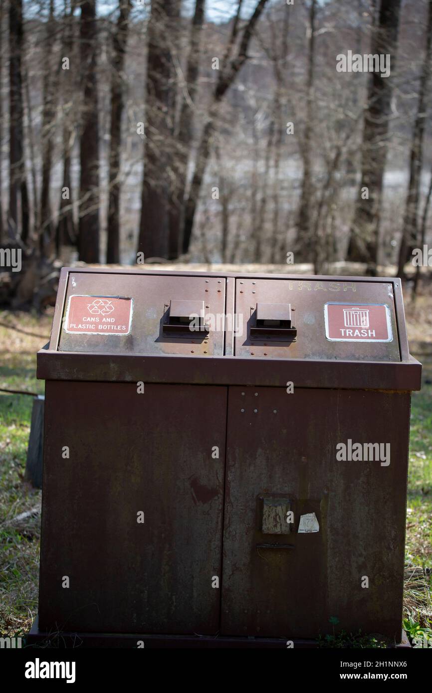 Large rusted receptacle for trash and aluminum and plastic recyclables