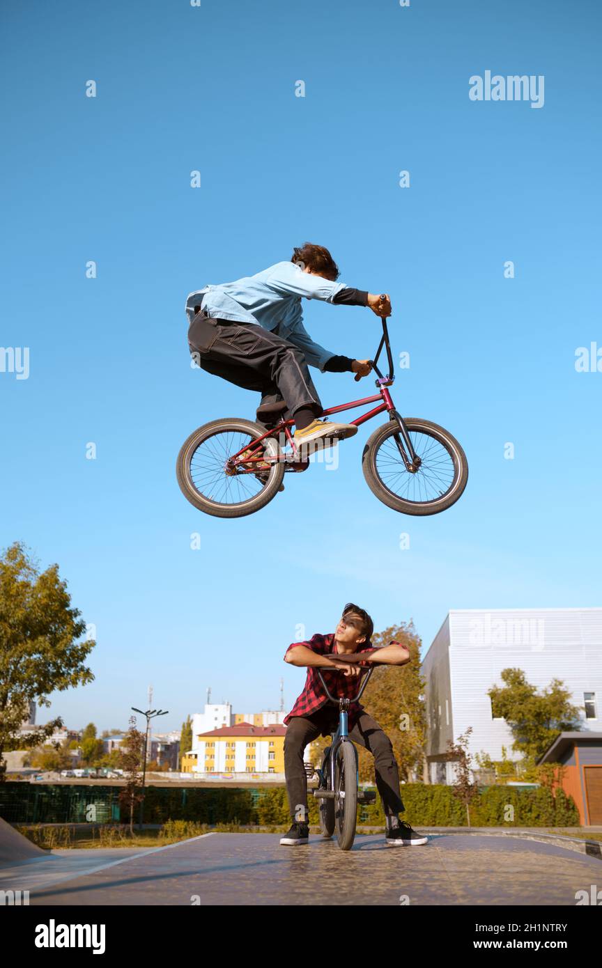 Bmx biker on ramp jump in action training in skatepark. Extreme bicycle sport dangerous cycle exercise street riding teens biking in summer park Stock Photo Alamy