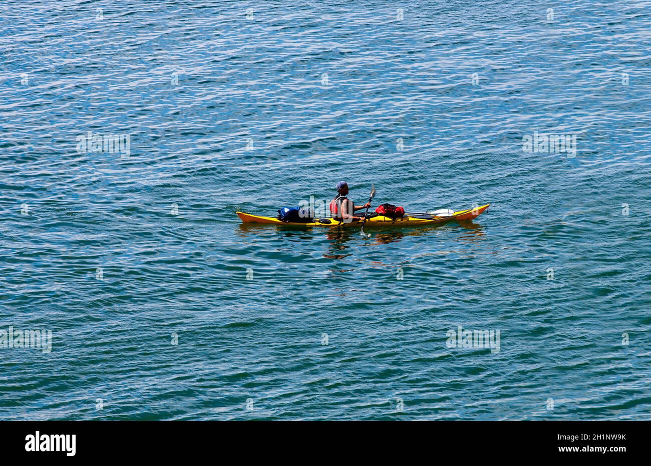A man in a sea kayak on Pasific ocean Stock Photo