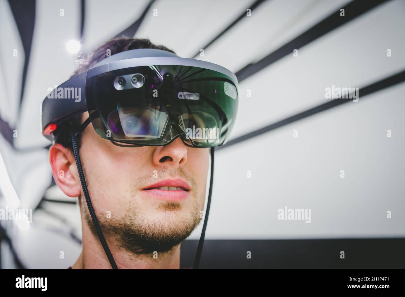 Young man is using virtual reality glasses or headset Stock Photo
