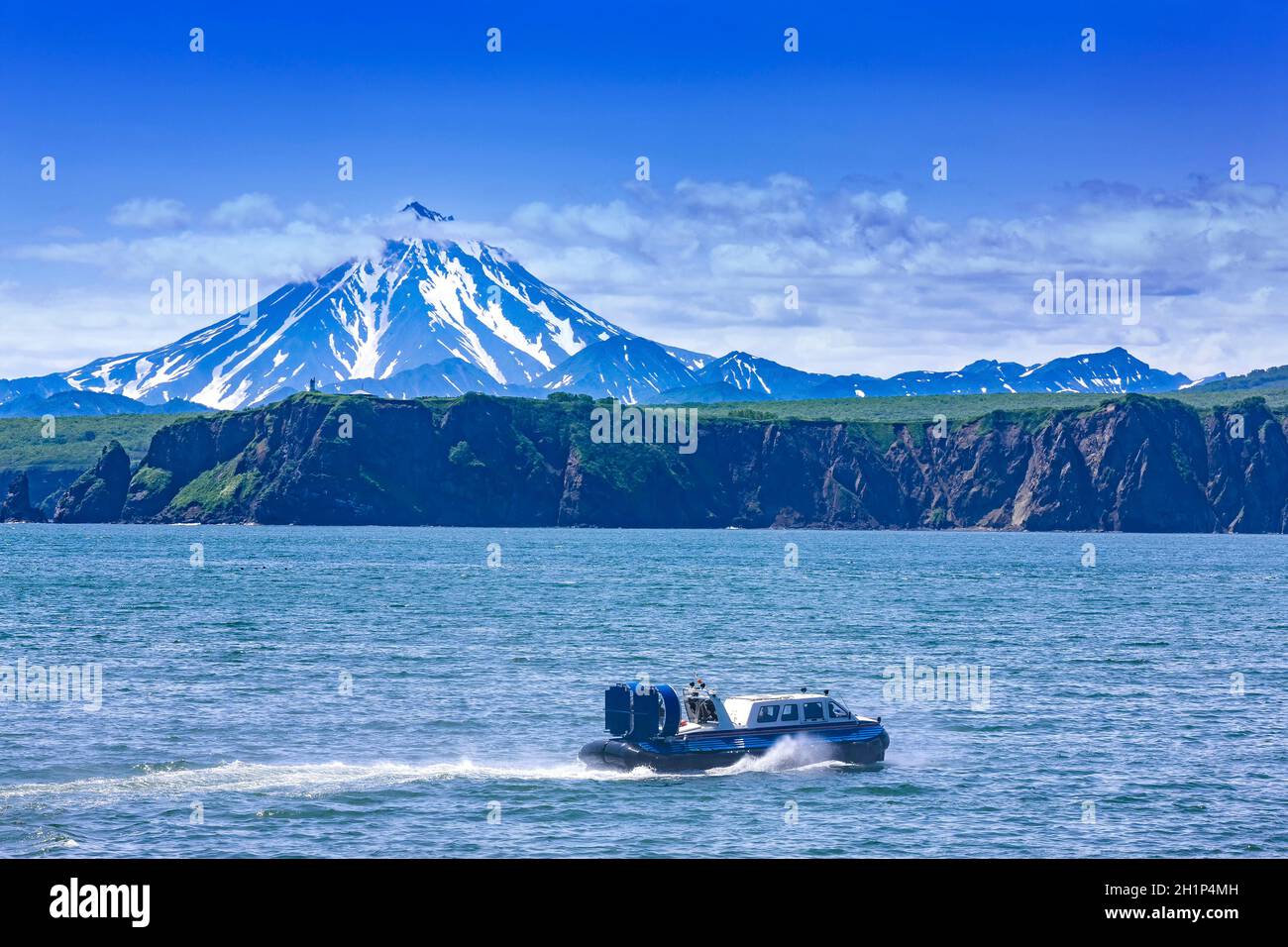 Hovercraft on Pasific ocean in kamchatka Peninsula on the background volcano Stock Photo