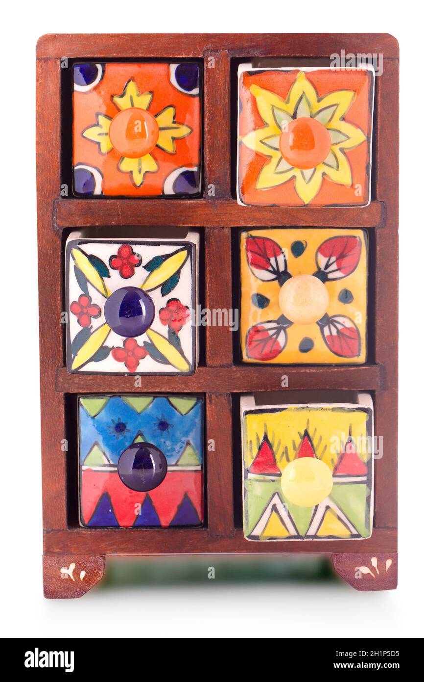 Small decorative stylish colorful printed oriental cupboard with foots with ceramic shelves on isolated background Stock Photo