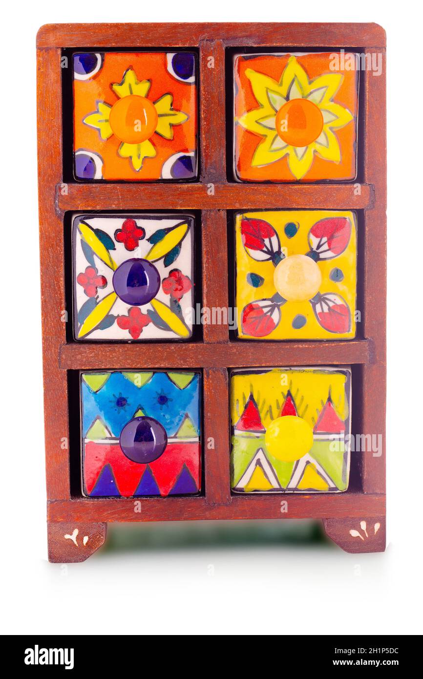 Small decorative stylish colorful printed oriental cupboard with foots with ceramic shelves on isolated background Stock Photo