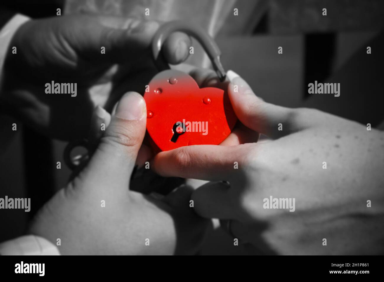 The newlyweds hold a red lock in their hand. Wedding Stock Photo - Alamy