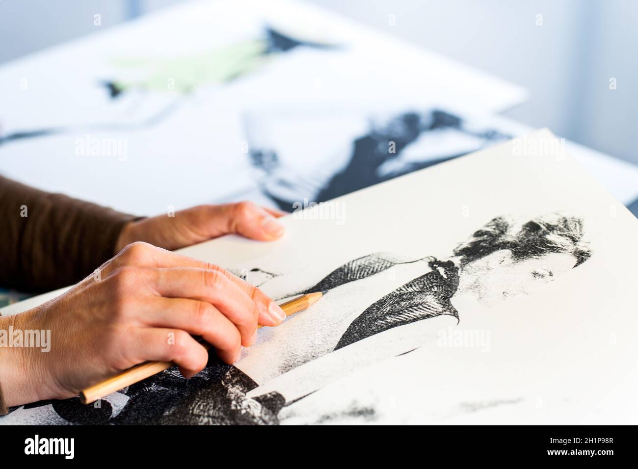 Extreme close up of female fashion designers hand creating fashion ...