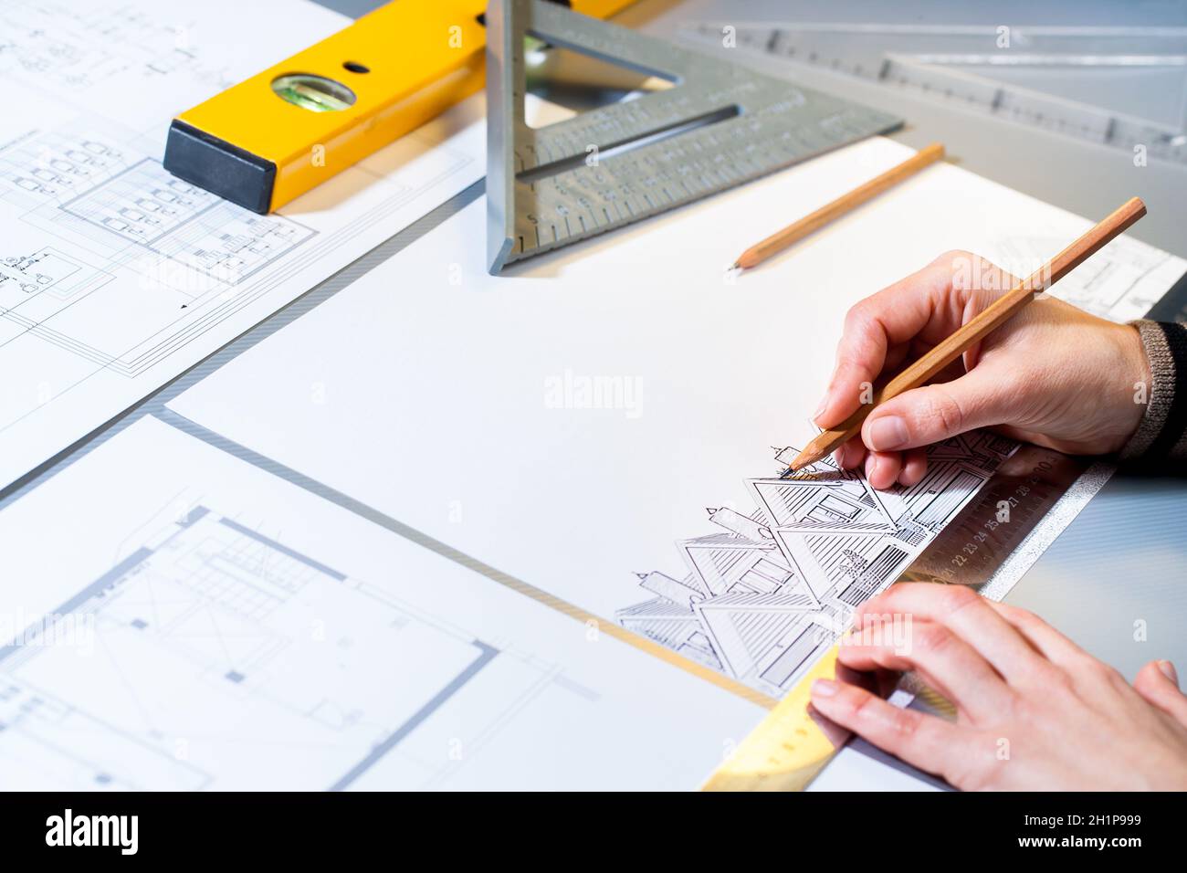 Macro close up of architect planning home layout with pencil. Stock Photo