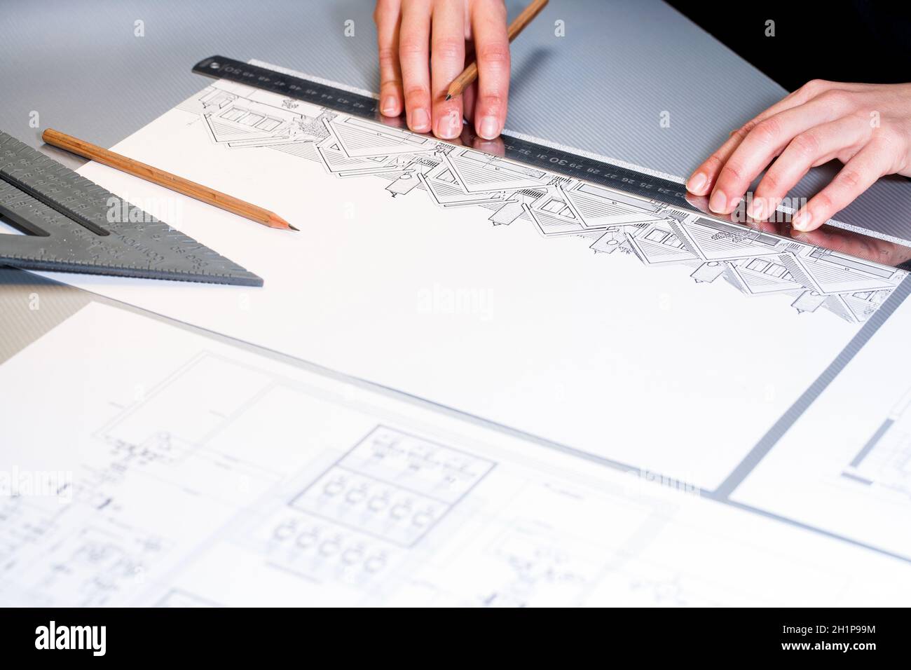 Macro close up of architects hands working on design document. Stock Photo