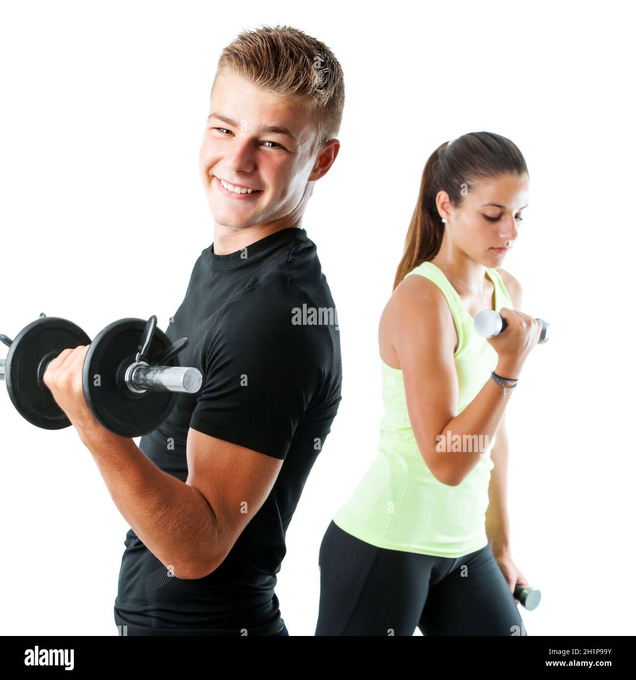 Close up portrait of handsome teen boy working out with weights.Out of focus girl working out in background.Isolated on white. Stock Photo