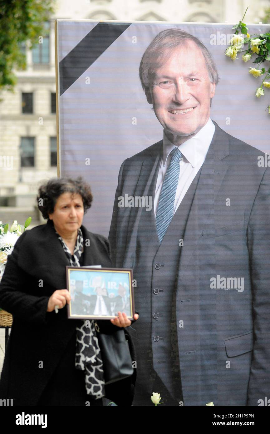 London, UK. 18th Oct, 2021. Iranians show respect for Sir David Amess MP on Parliament Square after his death for his support over the years for human rights and democracy. Sir David supported the pro-democracy opposition led by NCRI President-elect, Mrs Maryam Rajavi for more than 3 decades. Credit: JOHNNY ARMSTEAD/Alamy Live News Stock Photo