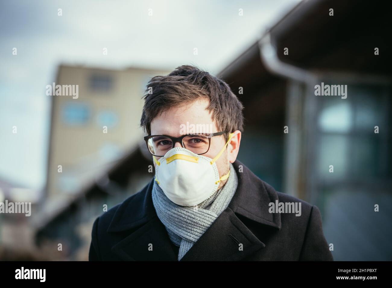 Young man outdoors with a breathing mask. Flue and corona season Stock Photo