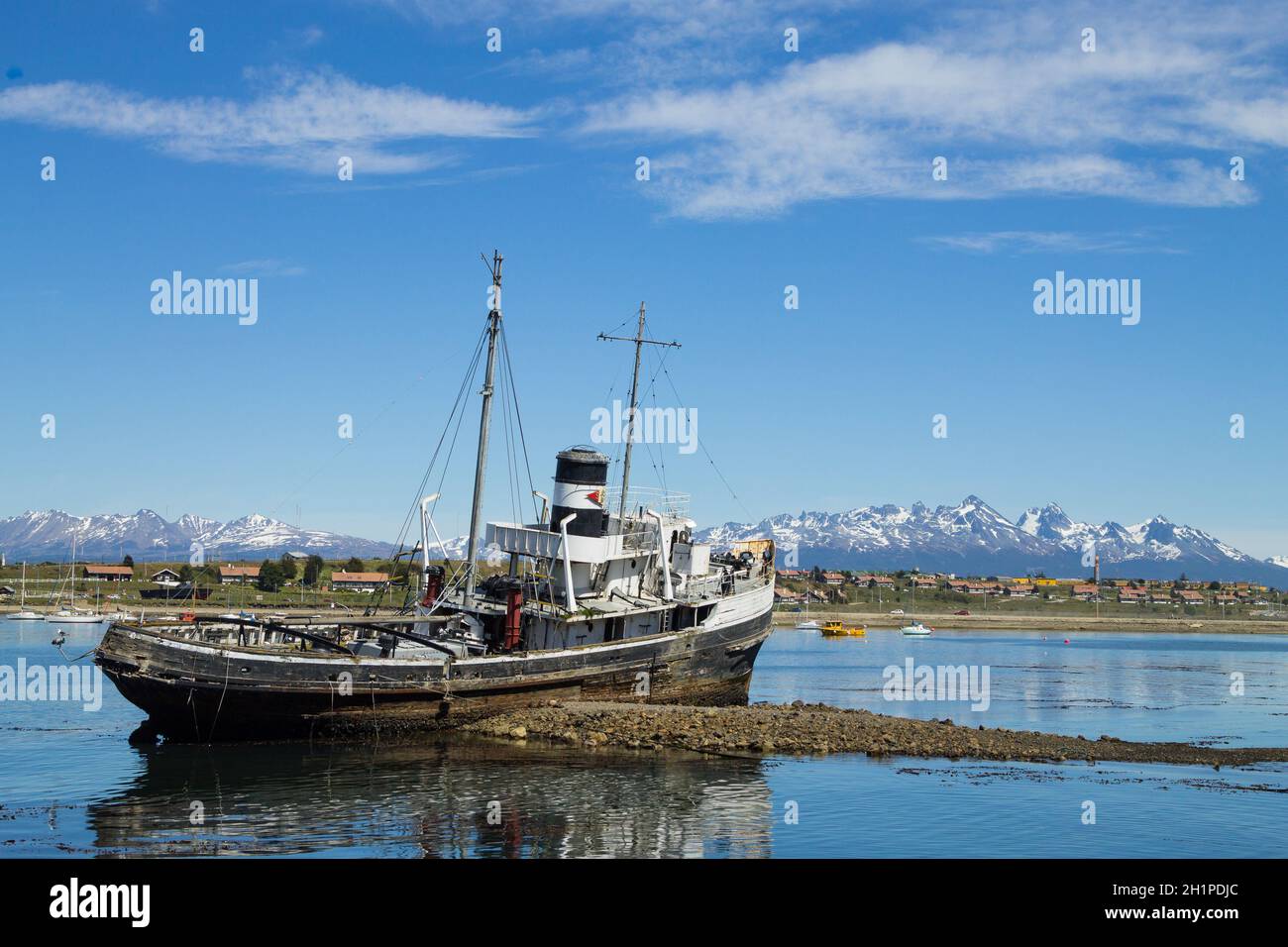 Southernmost city in the world. Beached ship on Ushuaia port, Argentina landscape Stock Photo