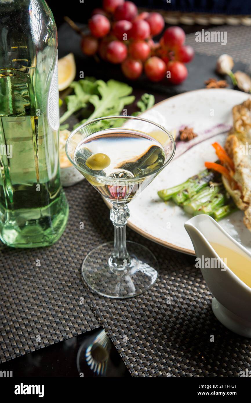 glass of semidry white wine, an aperitif. Wine with grilled meat and