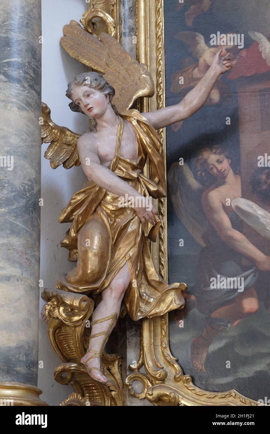 Angel statue on the St. Michael altar in the Neumunster Collegiate Church in Wurzburg, Germany Stock Photo