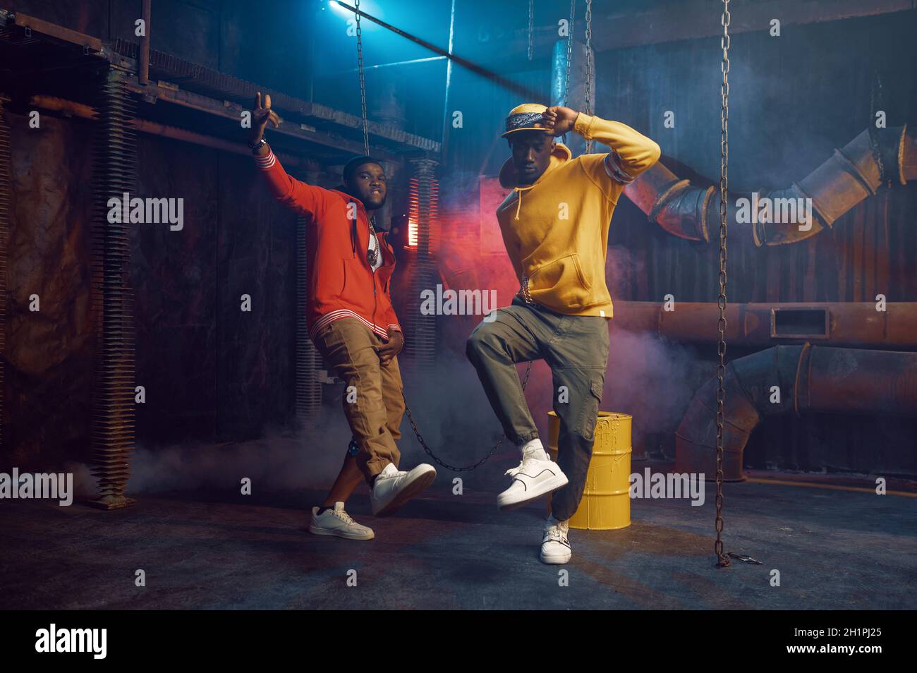 Two stylish rappers, breakdancing in studio with cool underground decoration Stock Photo