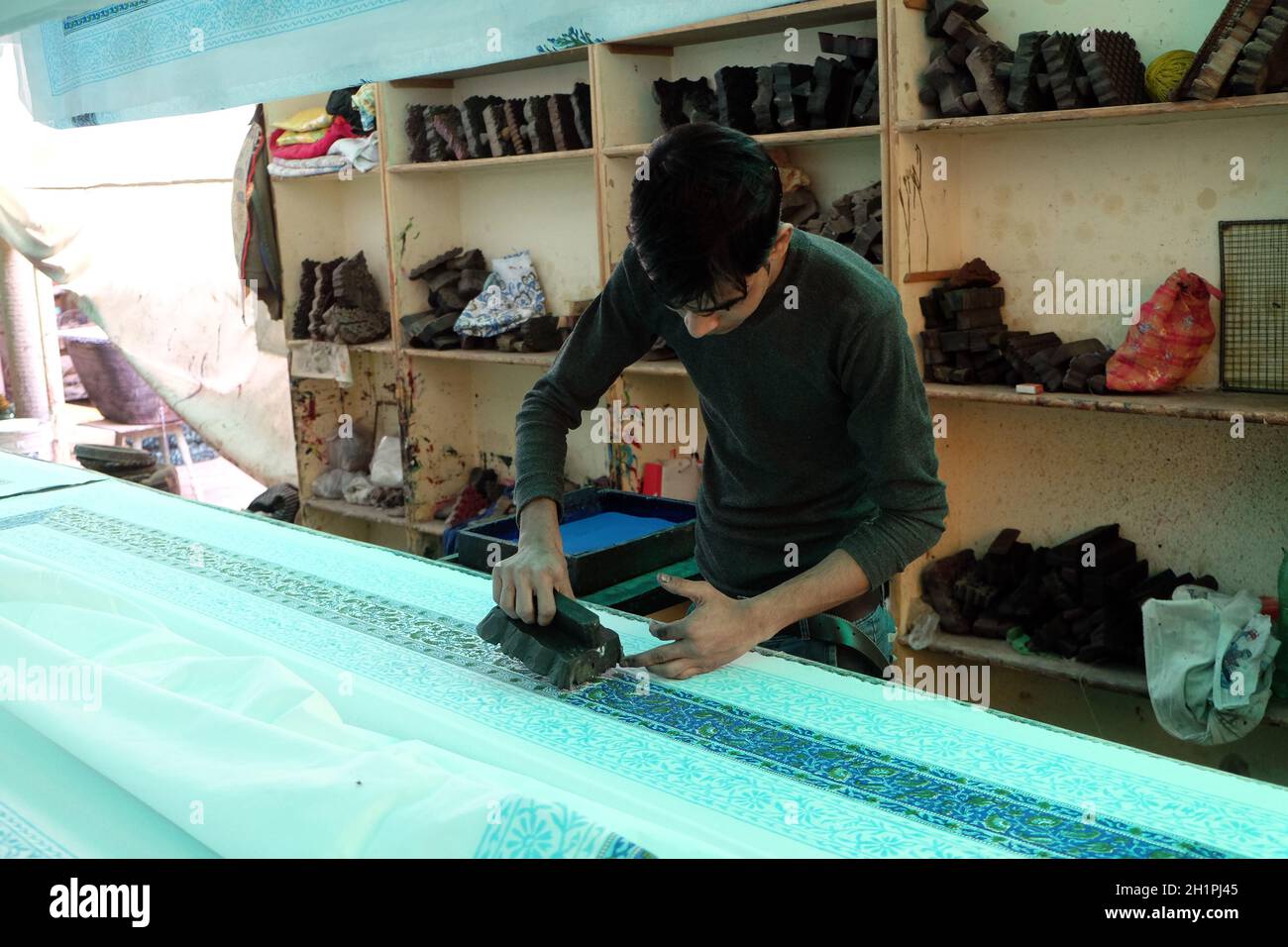 Craftsman decorating fabric with traditional wood blocks Silk Road