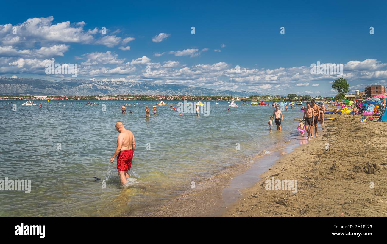 Nin Croatia July 2019 People Trouists Relaxing On Zdrijac Beach And nin-croatia-july-2019-people-trouists-relaxing-on-zdrijac-beach-and