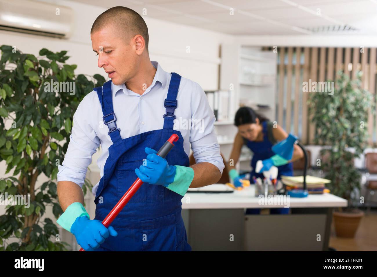 Janitor mopping office hi-res stock photography and images - Alamy