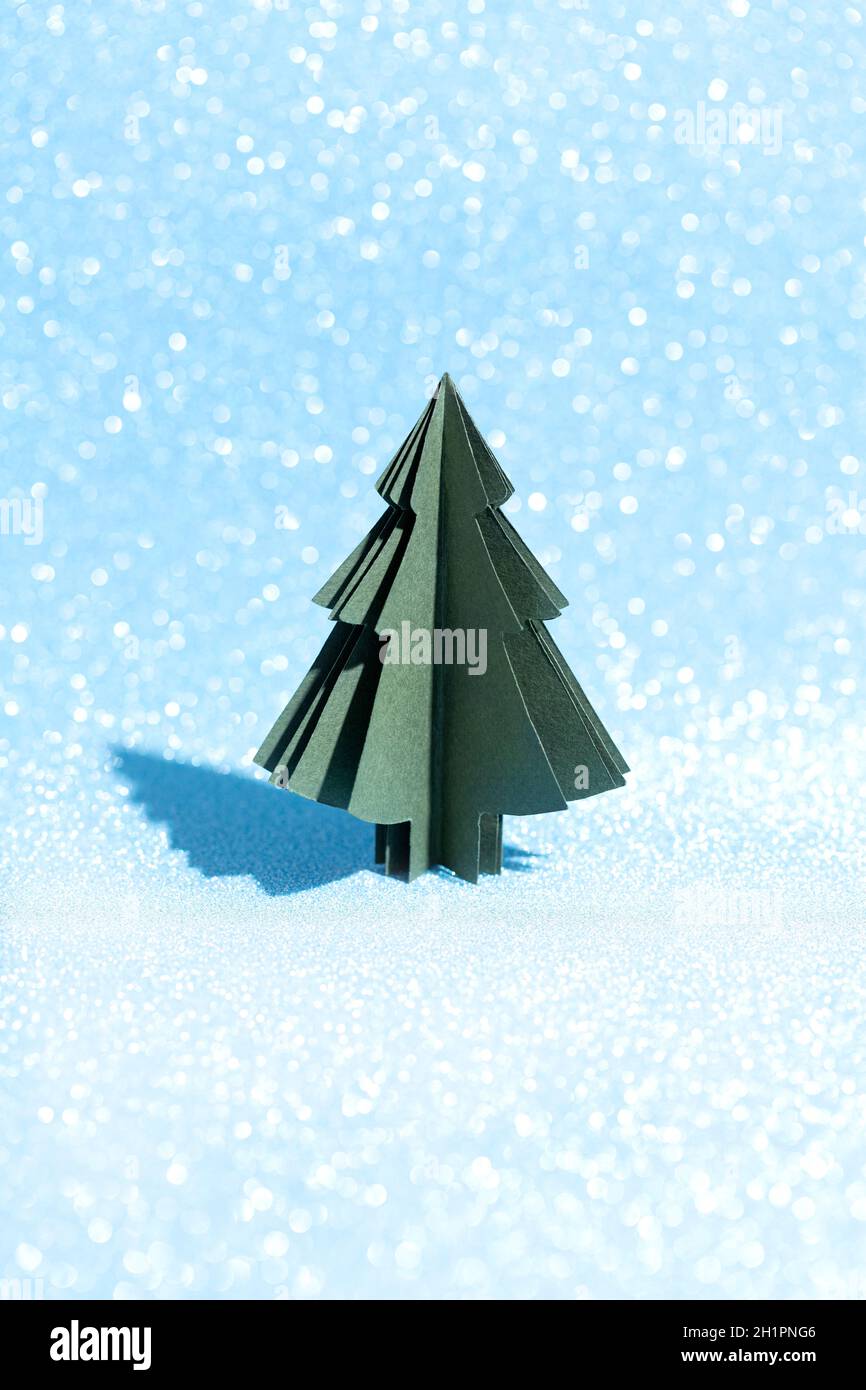 Christmas tree made of paper on a shiny blue background. Crafts by hand ...