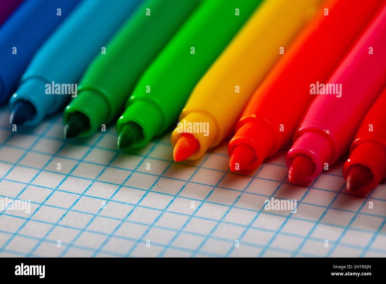 Image of opened multicolored markers on notepad Stock Photo