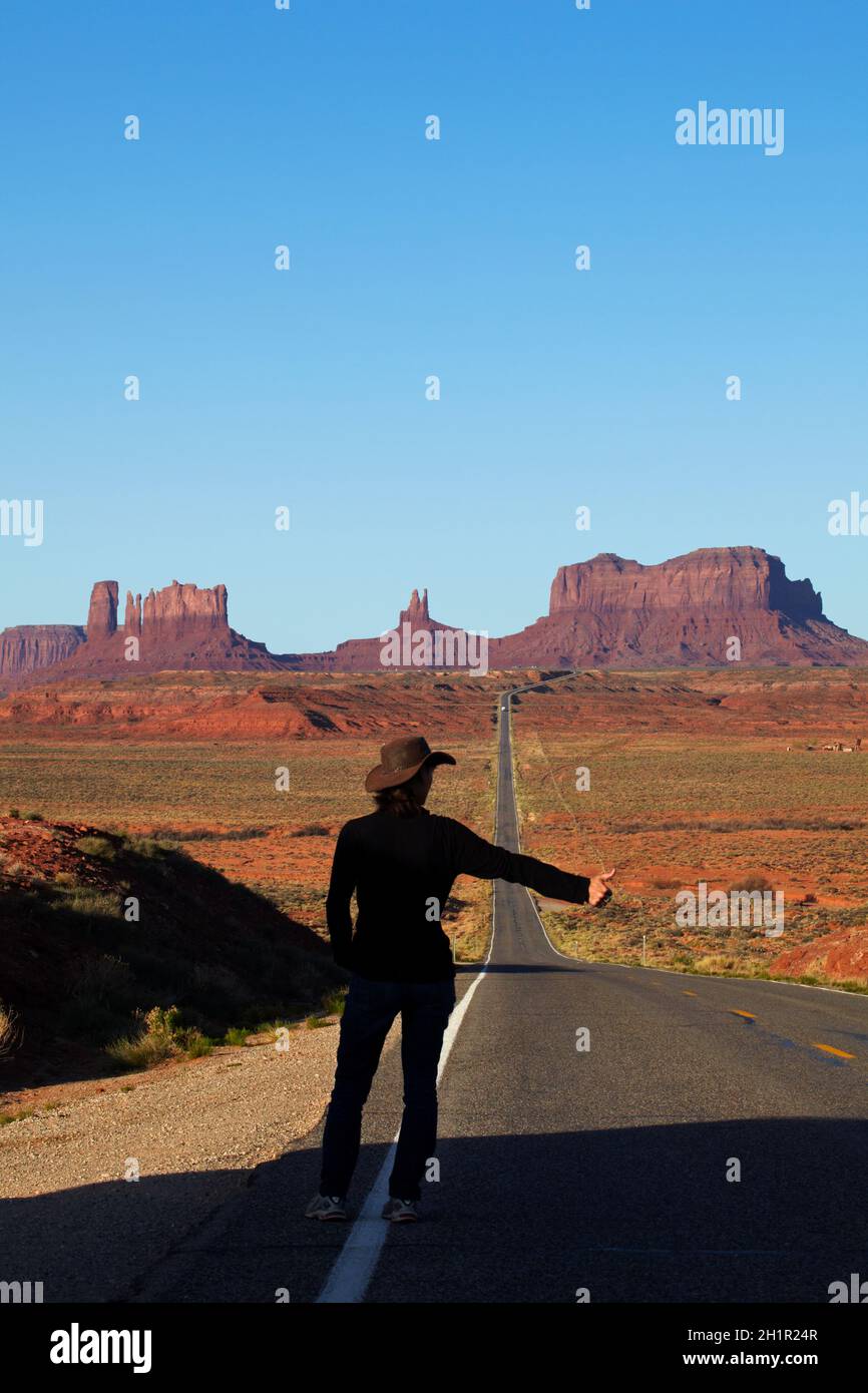 Hitch hiker on U.S. Route 163 heading towards Monument Valley, Navajo Nation, Utah, near Arizona Border, USA (model released) Stock Photo