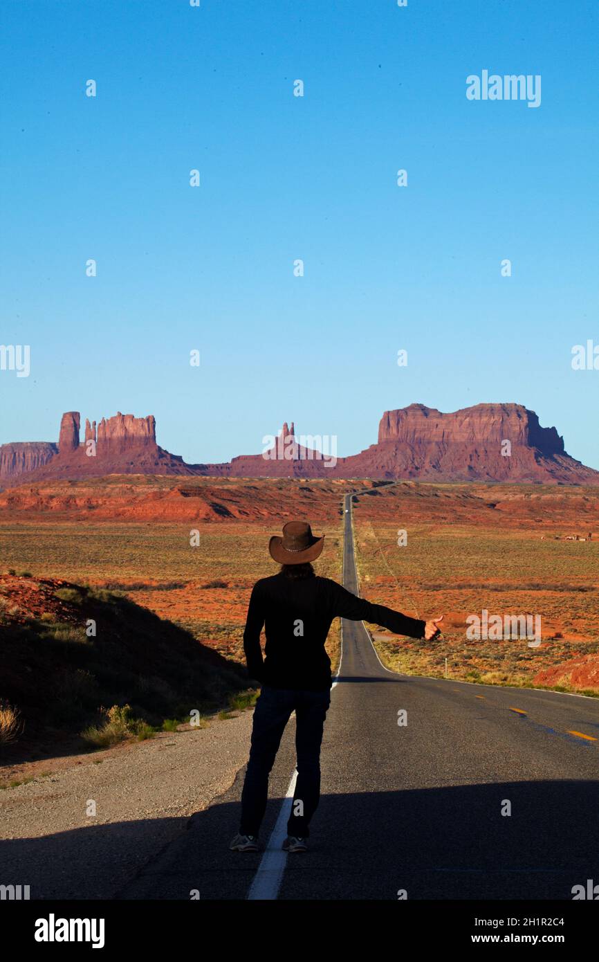 Hitch hiker on U.S. Route 163 heading towards Monument Valley, Navajo Nation, Utah, near Arizona Border, USA (model released) Stock Photo