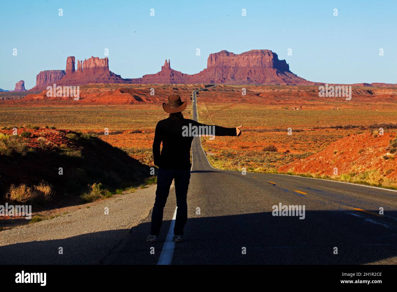 Hitch hiker on U.S. Route 163 heading towards Monument Valley, Navajo Nation, Utah, near Arizona Border, USA (model released) Stock Photo
