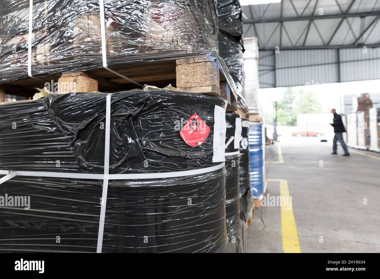 Flammable liquid waste with hazard warning symbol in the warehouse Stock Photo