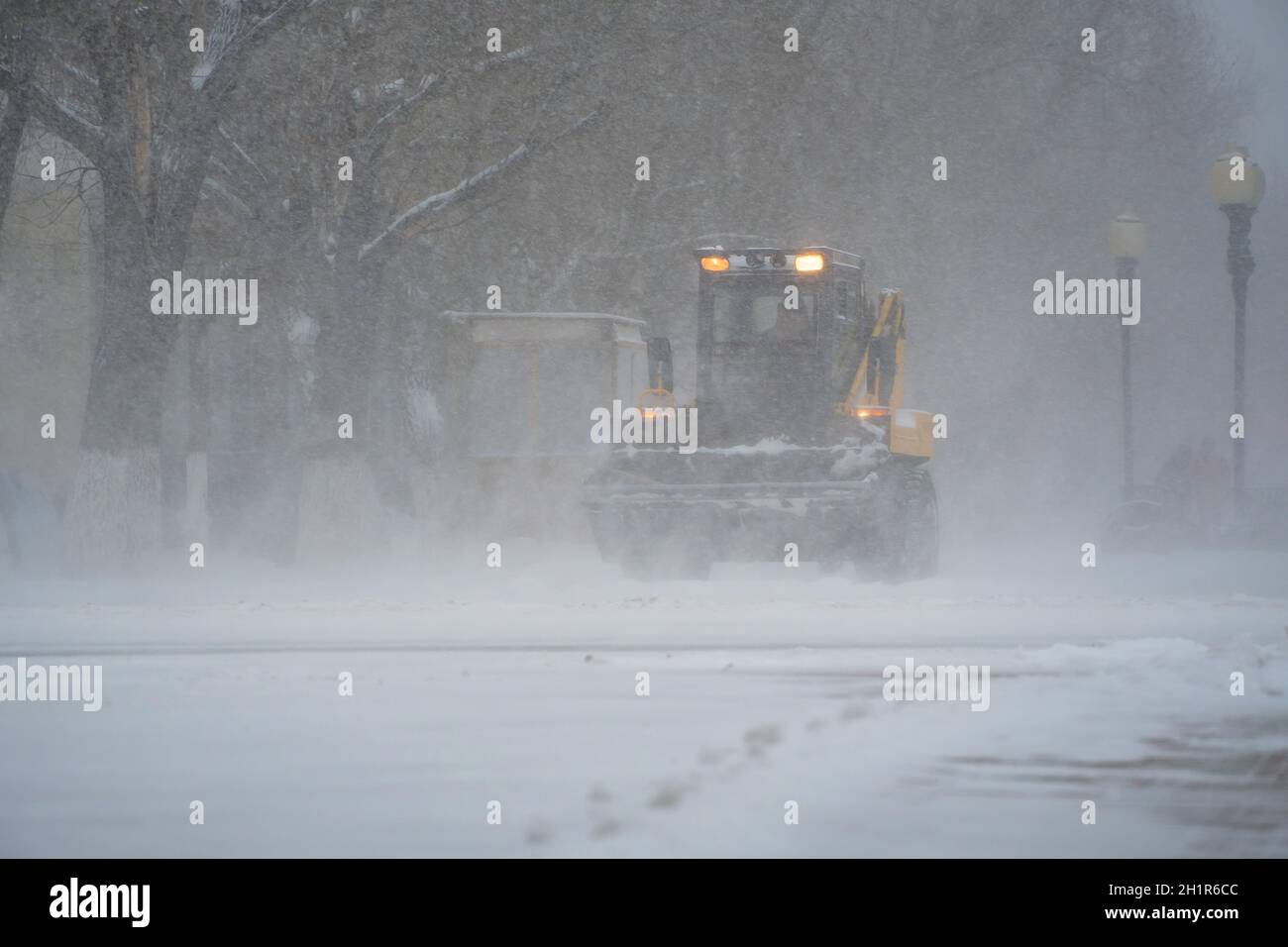 Snow removal equipment, utilities and municipal services are clearing the snow from the streets in the snow storm,Blizzard and snowstorm.Weather condi Stock Photo