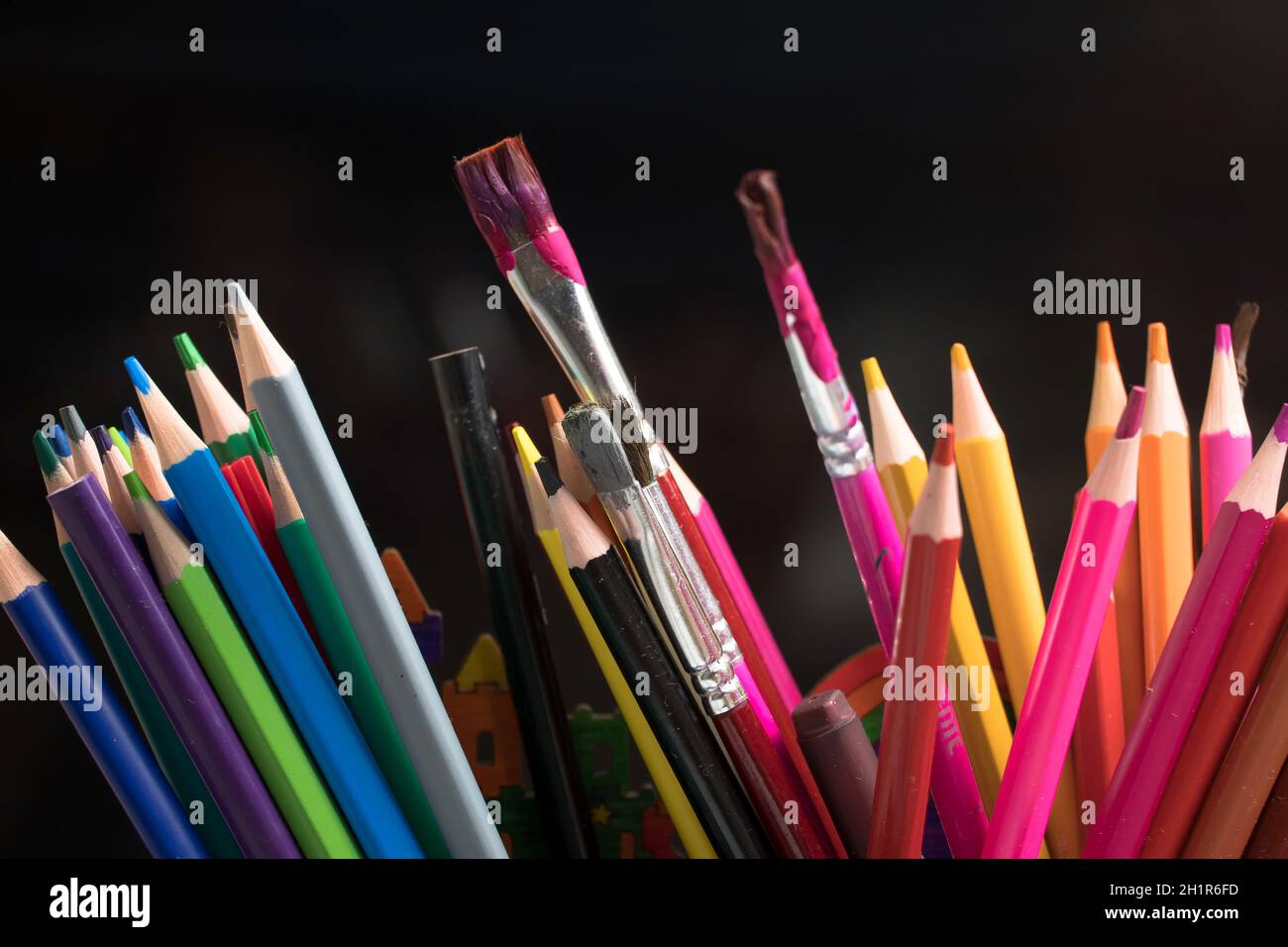 A set of colored pencils, stationery. Lots of colorful pencils on the table. Drawing and Visual Art Kits Stock Photo