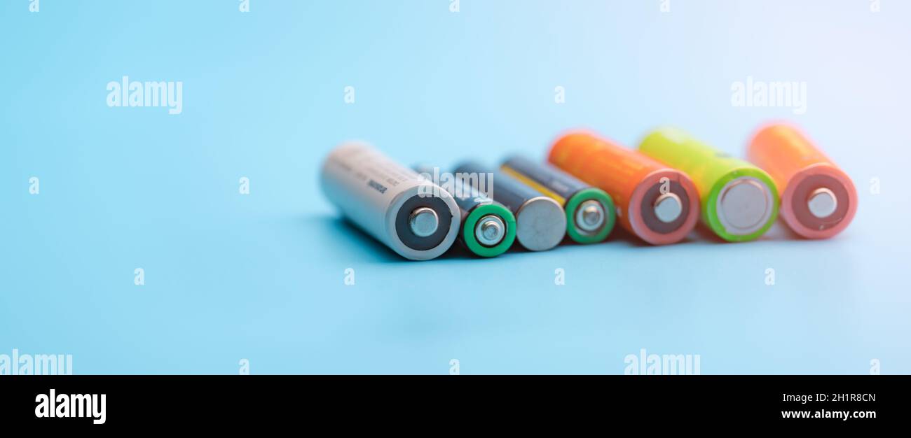 Rechargeable battery on blue background. Selective focus negative