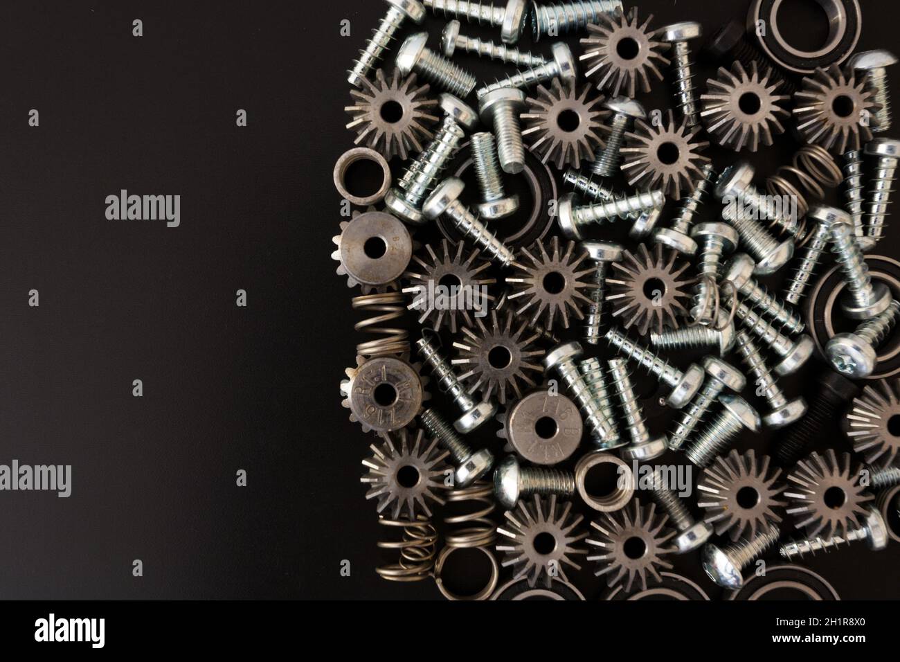Background with mechanical components, gears, springs, screws, industrial objects Stock Photo