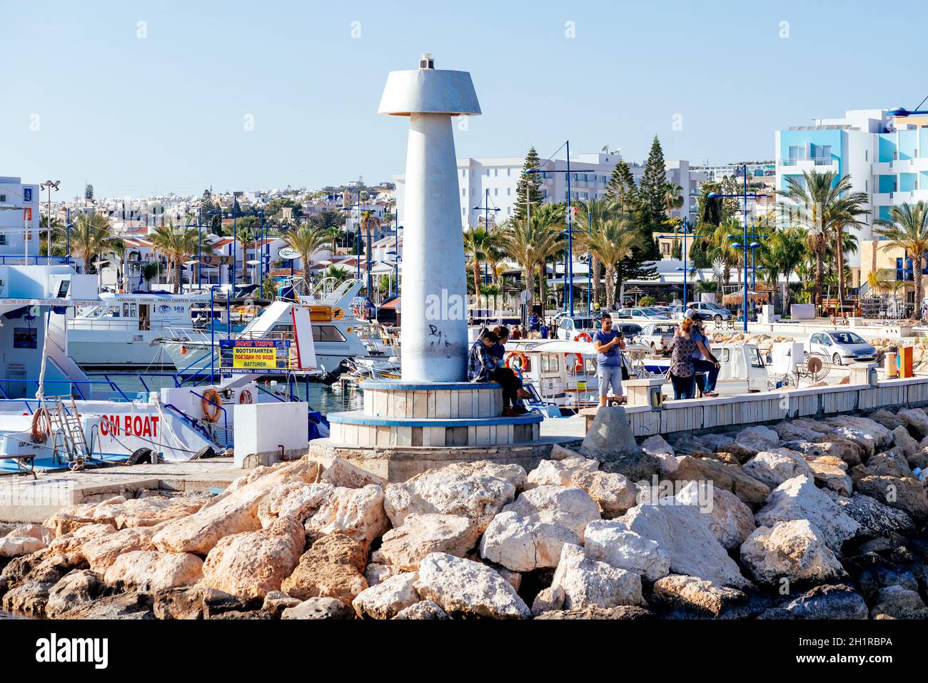 AGIA NAPA, CYPRUS - August 16 2020: People on the promenade at Agia Napa's port Stock Photo