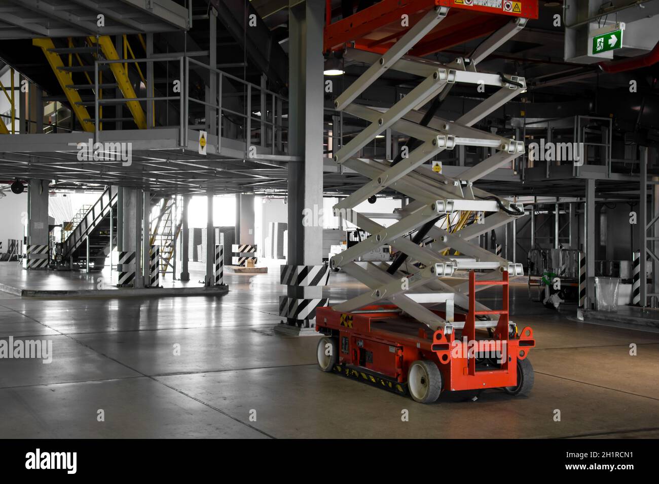 distribution warehouse hall with hydraulic scissors lift platform Stock