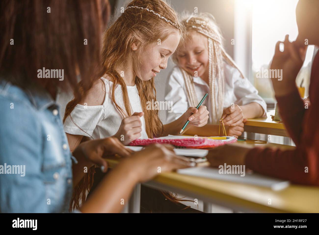 Girl holding pencil and drawing in a notebook Stock Photo - Alamy