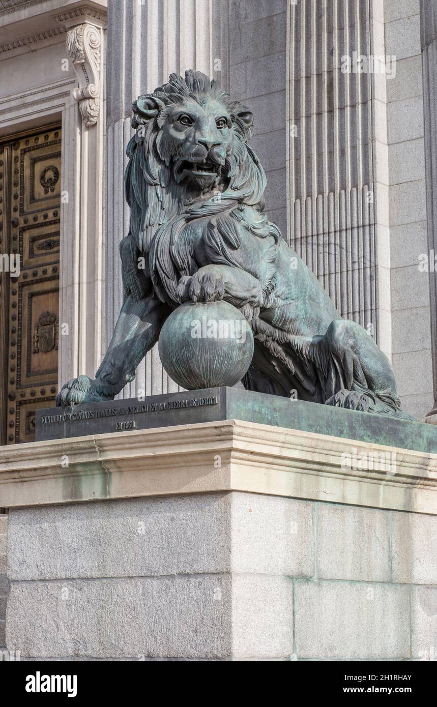 Spanish Congress of Deputies Building. Lion. Neoclassical Palace also called Palacio de las Cortes. Madrid, Spain Stock Photo