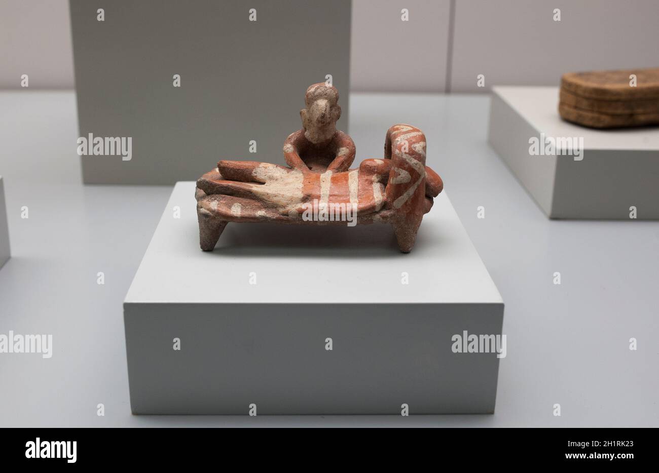 Madrid, Spain - Jul 11th, 2020: Healing ceremony by the laying on of hands by shaman. Ceramics. 400 BC. Colima style. Mexico. Museum of the Americas, Stock Photo