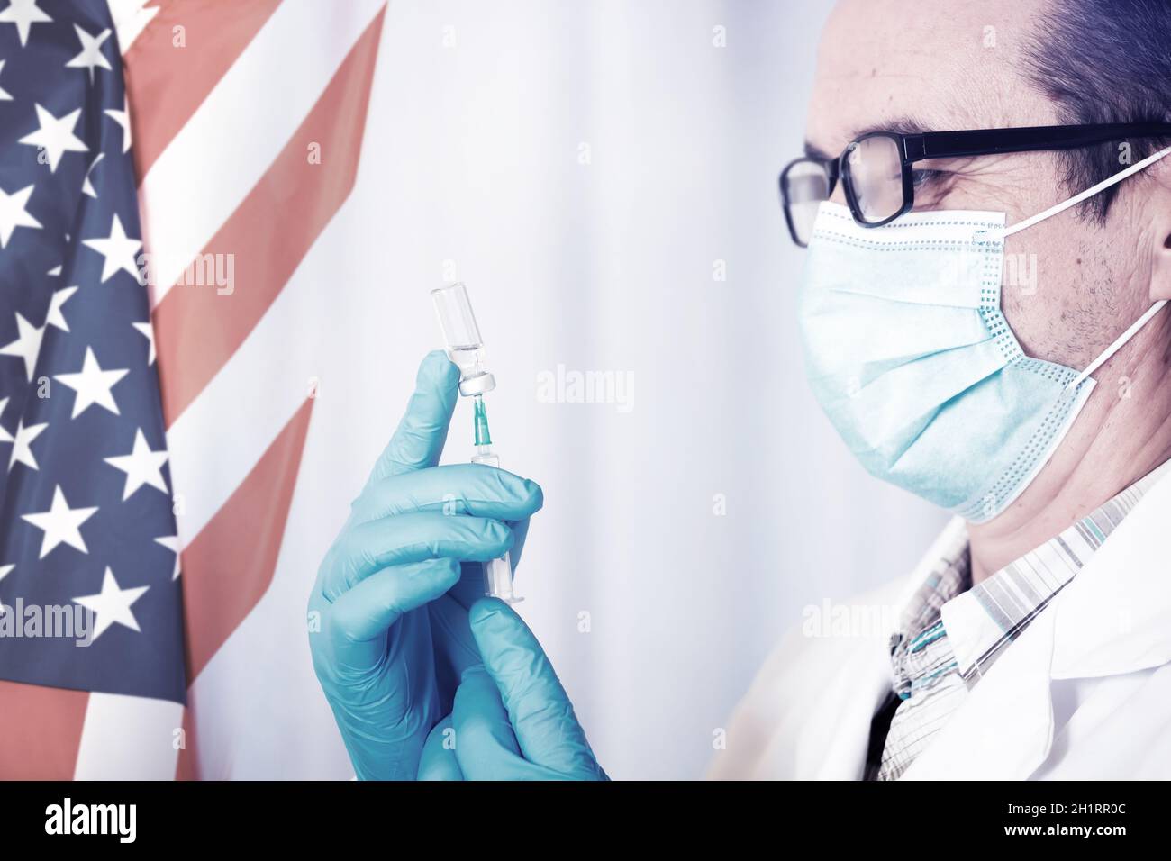 USA flag with doctor preparing for vaccine. Mass vaccination against the epidemic of coronavirus in USA  concept. Stock Photo