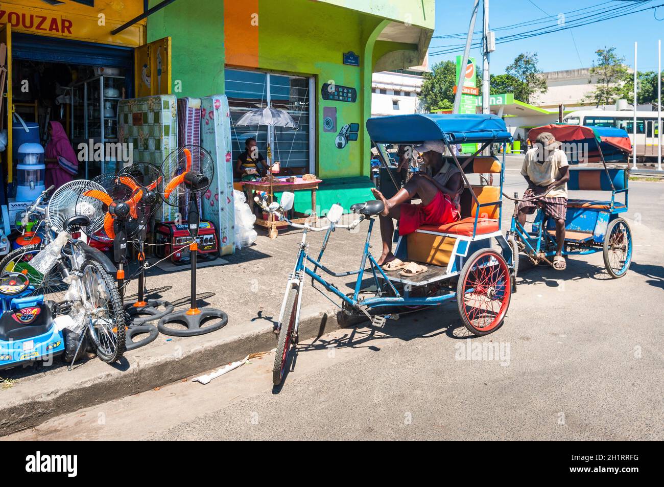 Toamasina, Madagascar - December 22, 2017: Malagasy rickshaws driver resting in his typical rickshaw padicab, traditional transportation in Toamasina Stock Photo