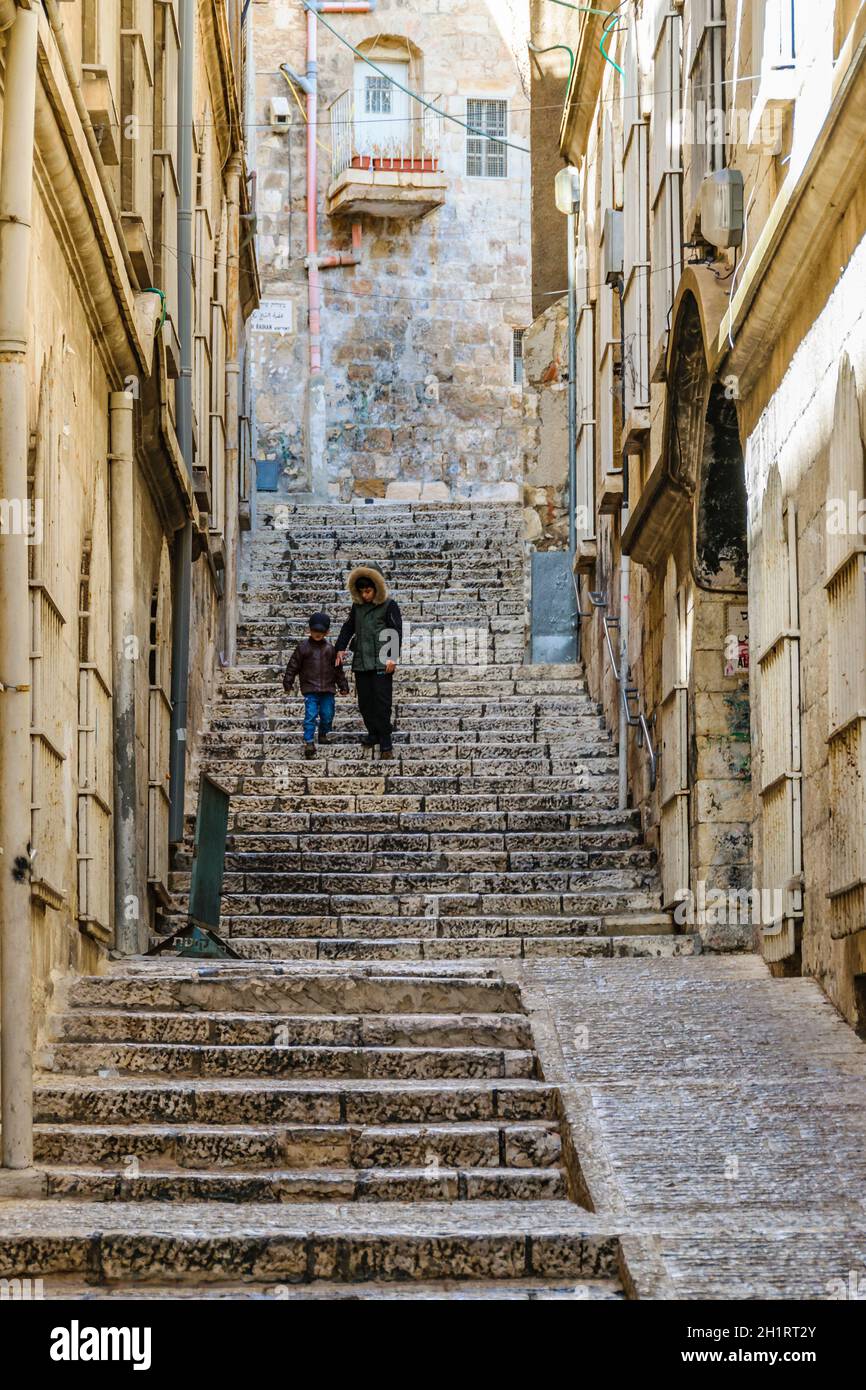 JERUSALEM, ISRAEL, DECEMBER - 2019 - Two kids going down the stairs, old jerusalem city Stock Photo