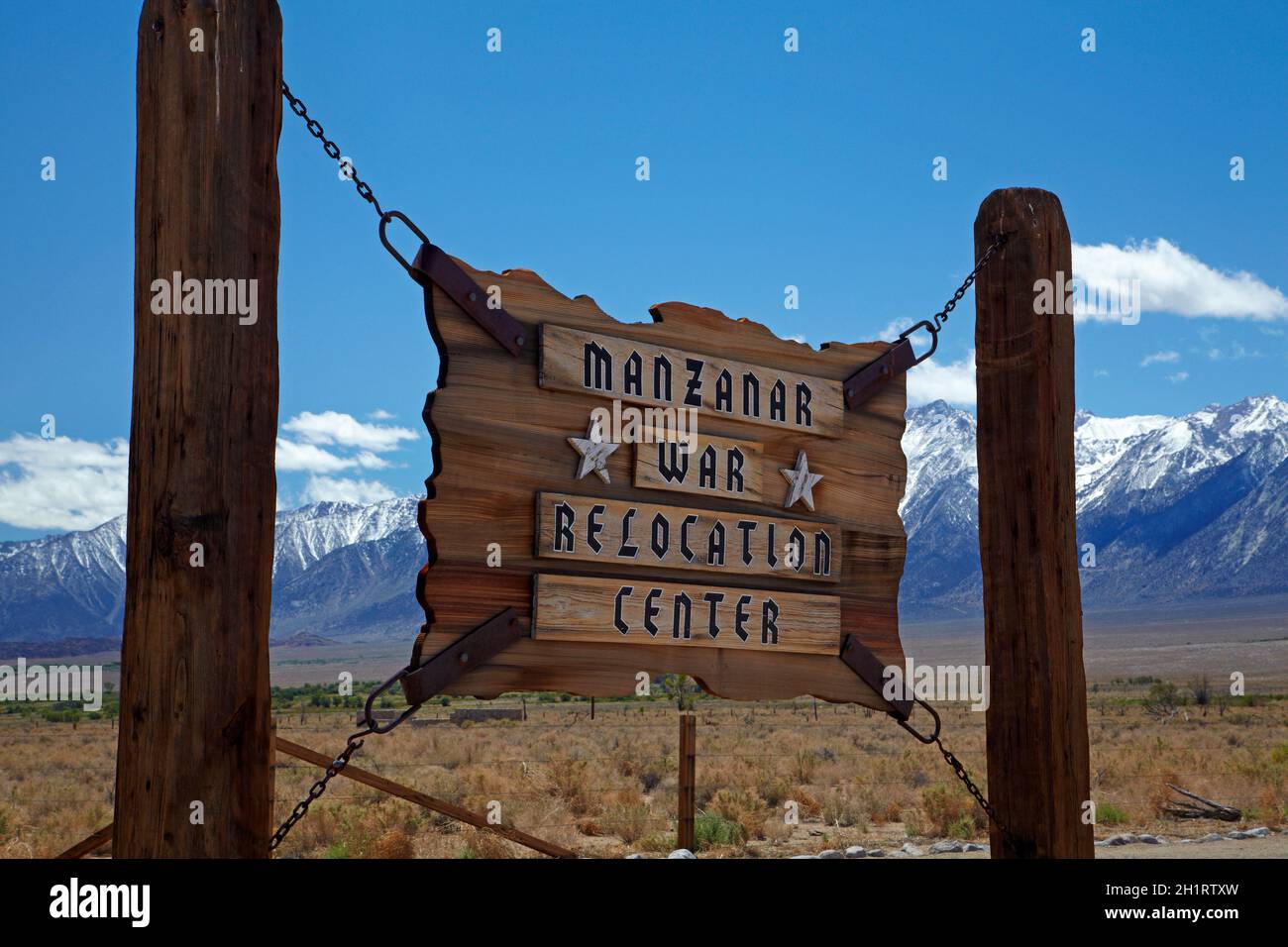 Sign for Manzanar War Relocation Center (WWII prison camp), and Sierra Nevada Mountain Range, near lone Pine, Owens Valley, California, USA Stock Photo