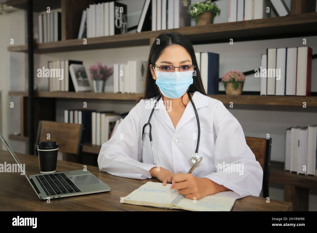 Doctor using laptop in office. Stock Photo