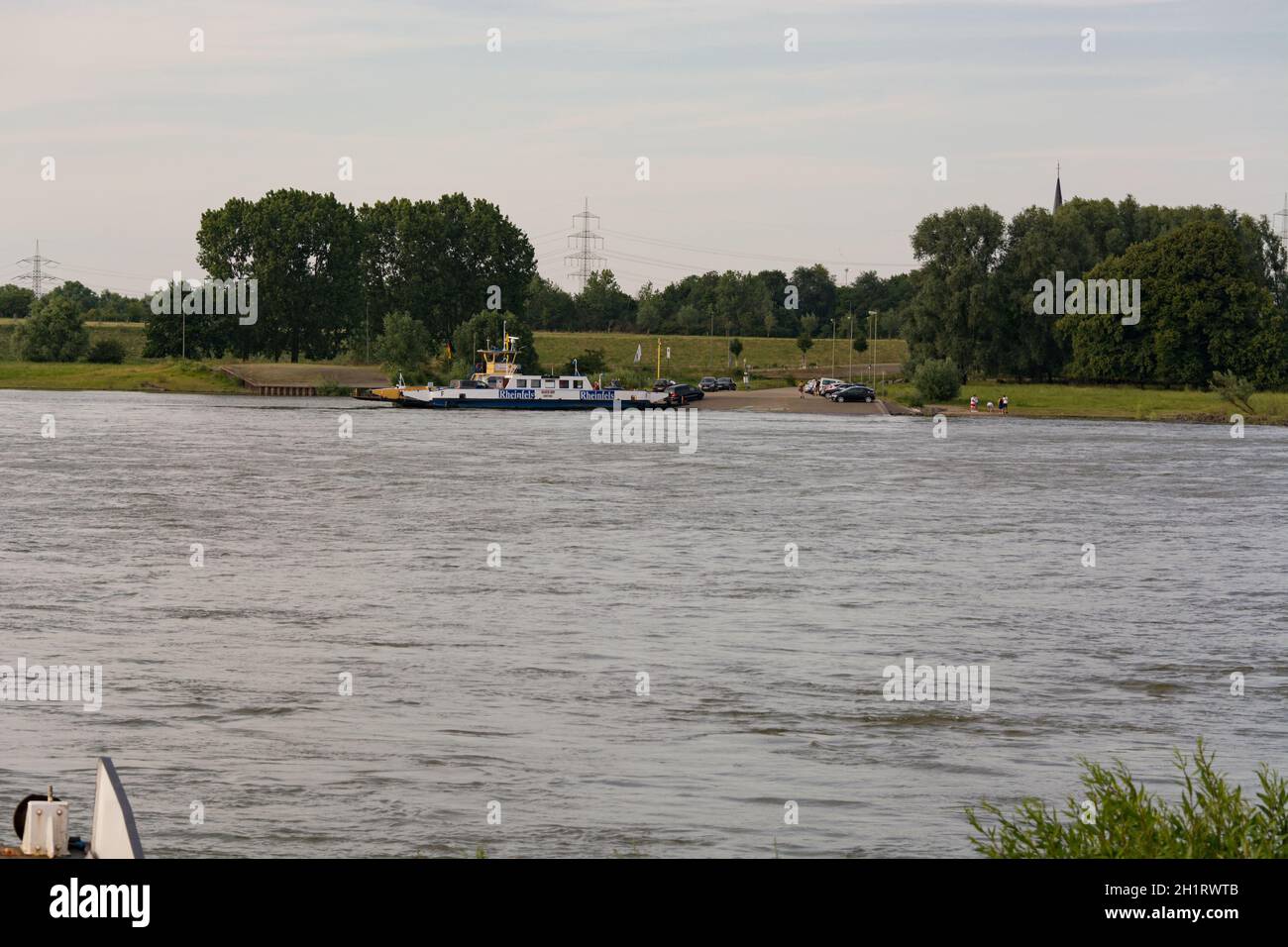 ORSOY, NRW, GERMANY - JUNE 23, 2019:  Ferry City Orsoy on the Rhine. The ferry connects Orsoy in NRW, the city of Duisburg Walsum. Some passengers on Stock Photo