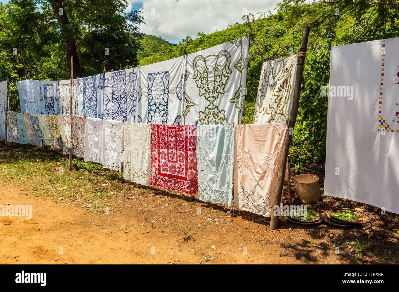 Ampasipohy, Nosy Be, Madagascar - December 19, 2015: Selling embroidered tablecloths in the village of the Ampasipohy, Nosy Be Island, Madagascar. It Stock Photo