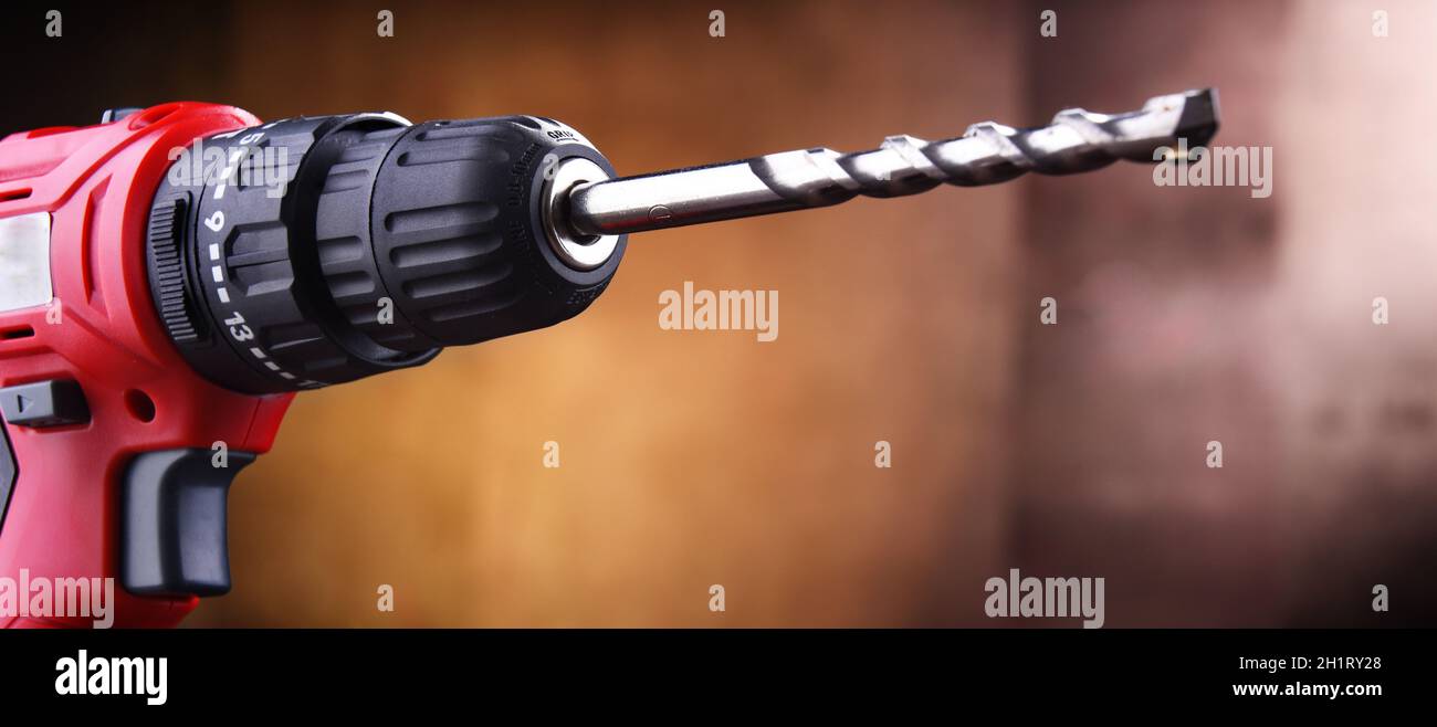 Composition with a cordless drill also working as a screw gun Stock Photo